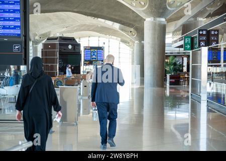 male and female walking in airport to catch there airplane Stock Photo