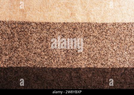 Beige and brown striped woolen knitted sweater fabric, texture, background. Stock Photo