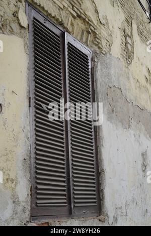 a close view from the window of a building with walls starting to peel Stock Photo