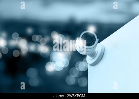 Modern security CCTV camera on building wall outdoors, space for text Stock Photo