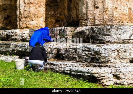 Restaurators working at Second Temple of Hera, belonging to the ruins of Paestum, an important ancient Greek city on the coast of the Tyrrhenian Sea. Stock Photo
