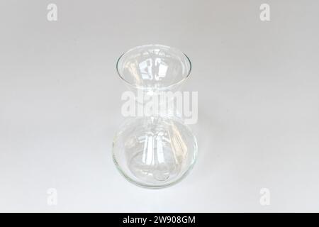 Clear glass vase isolated on a white background. Selective focus. Stock Photo