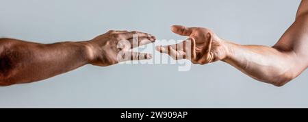 Hands reaching out to help or give. Two male hands reaching towards each other. Hands of man and woman reaching to each other. Two hands, helping arm Stock Photo