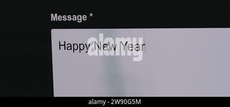 Typing Happy New Year in email Stock Photo