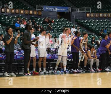 Honolulu, Hawaii, USA. 22nd Dec, 2023. Portland players cheer on their team during the Hawaiian Airlines Diamond Head Classic basketball game between the Massachusetts Minutemen and Portland Pilots at Sofi Arena in the Stan Sheriff Center in Honolulu, Hawaii. Glenn Yoza/CSM/Alamy Live News Stock Photo