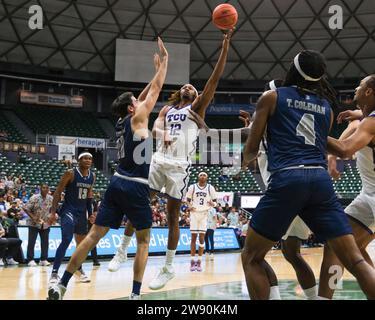 Honolulu, Hawaii, USA. 22nd Dec, 2023. TCU forward Xavier Cork (12) shoots the ball during the Hawaiian Airlines Diamond Head Classic basketball game between the TCU Horned Frogs and Nevada Wolf Pack at Sofi Arena in the Stan Sheriff Center in Honolulu, Hawaii. Glenn Yoza/CSM/Alamy Live News Stock Photo