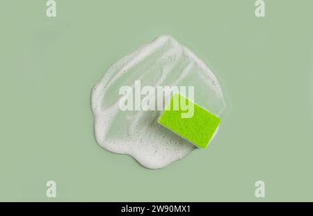 Washing Sponge lying on surface in soapy foam Stock Photo