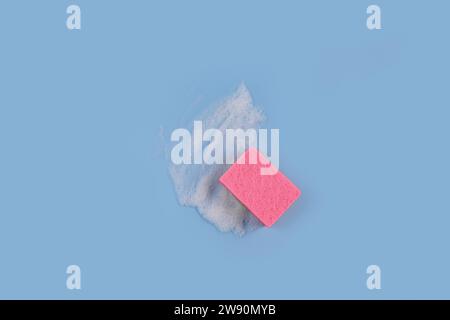 Washing Sponge lying on surface in soapy foam Stock Photo