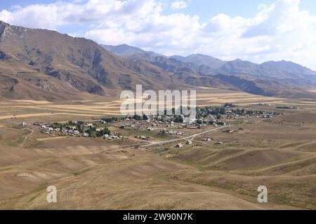 Mountain plateau over small village at road to Kazarman, district of Jalal-Abad Region in western Kyrgyzstan Stock Photo