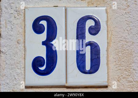Old Weathered House Number 36, Tile on Wall Stock Photo