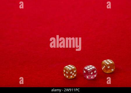 Three Dice with Value 6 on Red Velvet Playing Table - Gambling and Game Concept for Luck and Chance Games Stock Photo