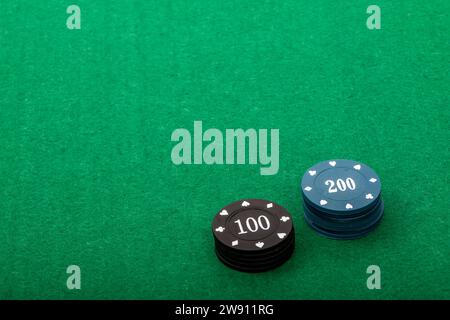 Stacks of Poker Chips on Green Felt Table, Background for Game Nights Stock Photo