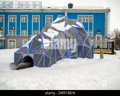 Murmansk, Russia - February 27, 2022: Children's ice slide in the form of an iceberg city of Murmansk Stock Photo