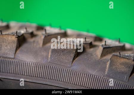detail of a black bicycle tire with fur on the surface. green background. Stock Photo