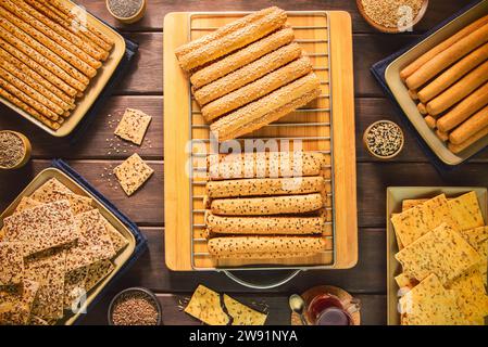 A variety of delicious crispy breadsticks (Grissini) and crackers with herbs and spices. Stock Photo
