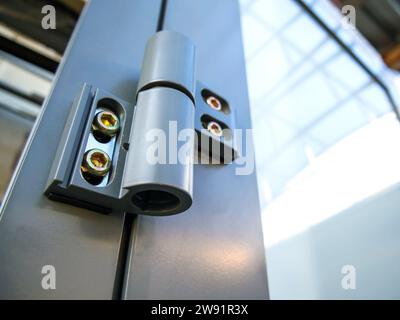 Hinge mounted on an aluminum profile door Stock Photo