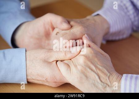 Close-up of senior couple holding hands Stock Photo