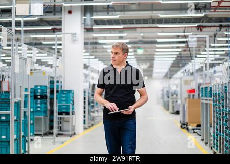 Technician using digital tablet on shop floor in a factory Stock Photo