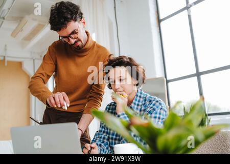 Thoughtful graphic designer working with colleague at office Stock Photo