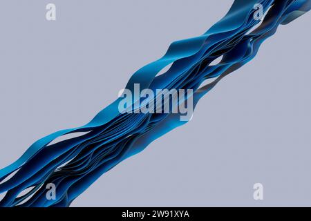 Layers of blue textiles flowing in wave pattern against gray background Stock Photo