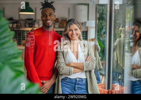 Confident multiracial business colleagues standing at cafe Stock Photo