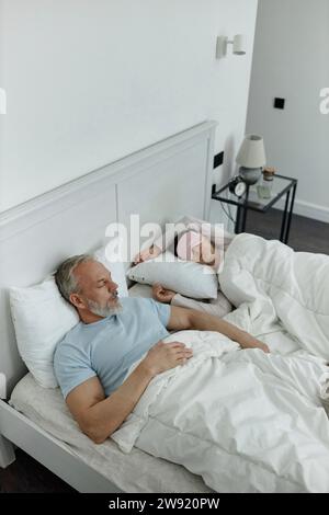 Couple sleeping together in bed in the morning Stock Photo