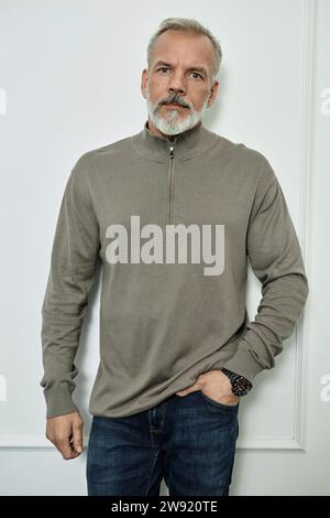 Pensive elderly man in casual clothes looking at camera Stock Photo