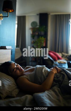 Woman sleeping on bed at home Stock Photo