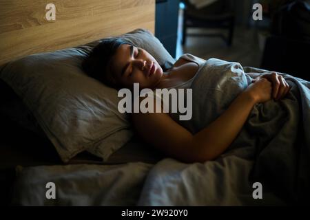Young woman sleeping on bed at home Stock Photo