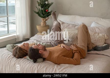 Couple lying together on bed at home Stock Photo