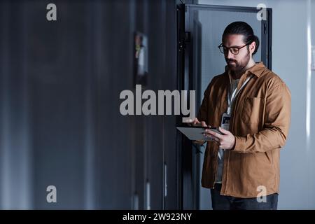 Engineer using tablet PC and working in data center Stock Photo