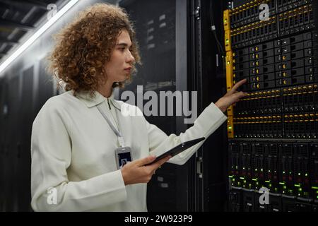 Technician checking supercomputer equipment in data center Stock Photo