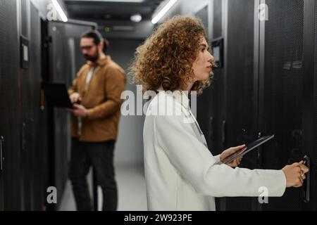 Young IT engineers working in server room Stock Photo