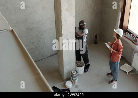 Engineer discussing over architectural column with coworker at construction site Stock Photo