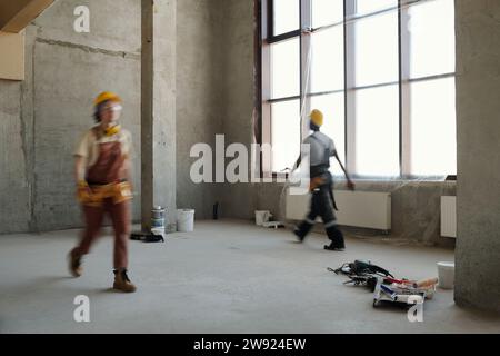 Construction workers walking at site Stock Photo