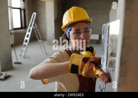 Construction worker wearing hardhat and working at site Stock Photo