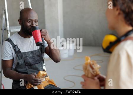 Construction workers taking lunch break at site Stock Photo