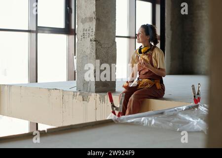 Smiling construction worker having lunch at site Stock Photo