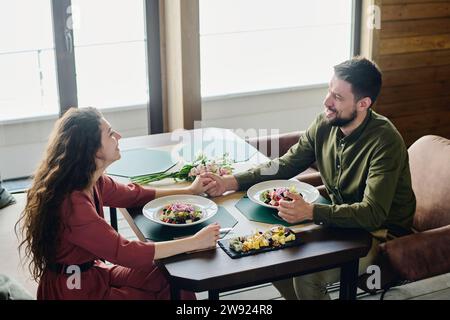 Happy couple having lunch date at restaurant Stock Photo