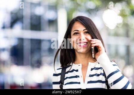 Happy woman talking on mobile phone Stock Photo