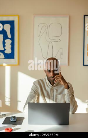 Businessman looking at laptop working remotely from home office Stock Photo
