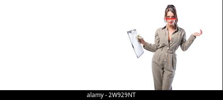 Woman interviewer stands in the studio on a white background with a tablet in her hand. Job interview concept. Recruiting and personnel selection. Stock Photo