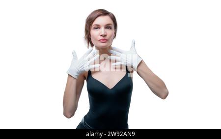 Surprised beautiful young woman in white gloves posing in the studio on a white background Stock Photo
