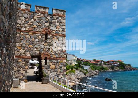 Ancient stone tower on a rocky coast with clear blue sky and calm sea, Architectural-historical complex, southern fortress wall and tower, Old Town Stock Photo