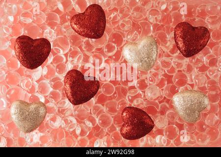 Abstract background in soft pastel peach colors with glitter hearts. Aesthetics of transparent balls. Trendy creative vaporwave gradient. Stock Photo