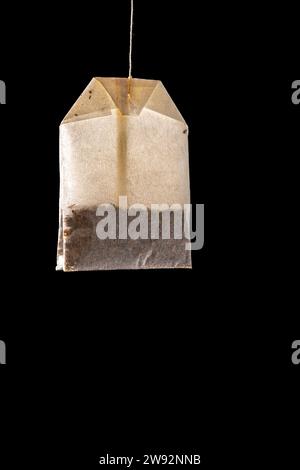 white translucent tea or infusion sachet on black color background. Stock Photo