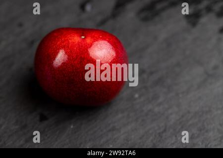 delicious sweet cherries on a slate board, delicious picked and pure cherry berries with pits Stock Photo