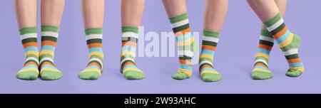 Woman in colorful socks on violet background, closeup. Collection of photos Stock Photo