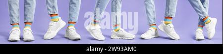 Woman in colorful socks, white sneakers and jeans on violet background, closeup. Collection of photos Stock Photo