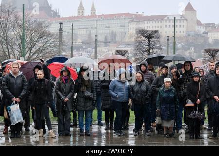 Prague, Czech Republic. 23rd Dec, 2023. People observe a minute of silence near the building of the Faculty of Arts of Charles University in Prague, the Czech Republic, Dec. 23, 2023. The Czech Republic on Saturday mourned the victims of a university shooting in the capital Prague that has left 14 people dead. On Thursday, a 24-year-old student from the faculty shot and killed 14 people before committing suicide. The tragic incident also left 25 others injured, among whom, three were foreigners, according to police. Credit: Deng Yaomin/Xinhua/Alamy Live News Stock Photo